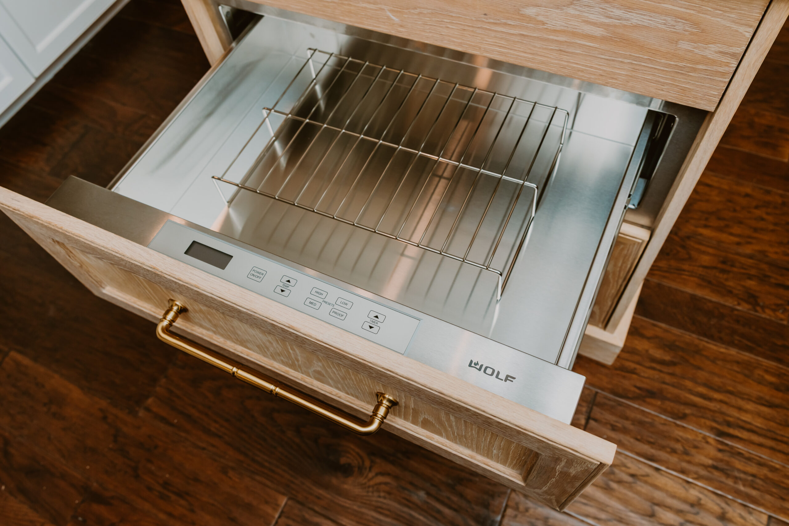 Warming Drawer Located in a White Oak Kitchen Island Warming Drawer Located in a White Oak Kitchen Island